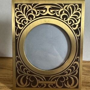 Vintage brass frame with delicate pattern outline in black. Unique circle center